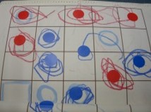 赤と青の丸に、それぞれ同じ色のシールが張られた教具のイメージ